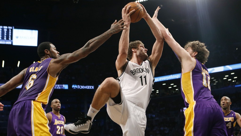 Brooklyn Nets' Lopez shoots over Los Angeles Lakers' Gasol and Clark in the fourth quarter of their NBA basketball game in Brooklyn, New York