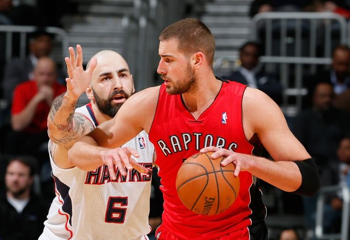 ATLANTA, GA - MARCH 18: Pero Antic #6 of the Atlanta Hawks defends against Jonas Valanciunas #17 of the Toronto Raptors at Philips Arena on March 18, 2014 in Atlanta, Georgia. NOTE TO USER: User expressly acknowledges and agrees that, by downloading and or using this photograph, User is consenting to the terms and conditions of the Getty Images License Agreement. (Photo by Kevin C. Cox/Getty Images)