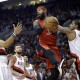 Toronto Raptors forward James Johnson, middle, looks to pass as Portland Trail Blazers' LaMarcus Aldridge, right, and Nicolas Batum, from France, defend during the first half of an NBA basketball game in Portland, Ore., Tuesday, Dec. 30, 2014.(AP Photo/Don Ryan)