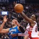 Toronto Raptors forward Patrick Patterson, right, eyes the ball against Orlando Magic forward Nikola Vucevic (9) during second half NBA basketball action in Toronto on Monday, Dec. 15, 2014. (AP Photo/The Canadian Press, Nathan Denette)