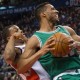 Boston Celtics' Evan Turner, right, backs into Toronto Raptors' Kyle Lowry during the first half of their NBA basketball game in Toronto on Saturday Jan. 10, 2015. (AP Photo/The Canadian Press, Chris Young)