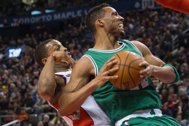 Boston Celtics' Evan Turner, right, backs into Toronto Raptors' Kyle Lowry during the first half of their NBA basketball game in Toronto on Saturday Jan. 10, 2015. (AP Photo/The Canadian Press, Chris Young)
