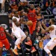 Phoenix Suns' Eric Bledsoe, center, dishes off to Marcus Morris (15) as Toronto Raptors' Patrick Patterson (54) and Lou Williams (23) defend during the first half of an NBA basketball game, Sunday, Jan. 4, 2015, in Phoenix. (AP Photo/Matt York)