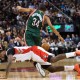 Toronto Raptors forward Amir Johnson, front, trips up Milwaukee Bucks forward Giannis Antetokounmpo (34) during the first half of an NBA basketball game in Toronto, Monday, Feb. 2, 2015. (AP Photo/The Canadian Press, Nathan Denette)