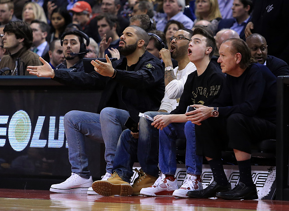 TORONTO, ON - MARCH 28: Rapper Drake gestures to a call by the official during the second half of an NBA game between the Oklahoma City Thunder and the Toronto Raptors at the Air Canada Centre on March 28, 2016 in Toronto, Ontario, Canada. NOTE TO USER: User expressly acknowledges and agrees that, by downloading and or using this photograph, User is consenting to the terms and conditions of the Getty Images License Agreement. (Photo by Vaughn Ridley/Getty Images)
