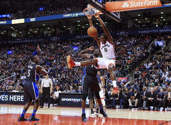 TORONTO, ON - MARCH 20: Bismack Biyombo #8 of the Toronto Raptors dunks the ball as Dewayne Dedmon #3 of the Orlando Magic defends during the second half of an NBA game at the Air Canada Centre on March 20, 2016 in Toronto, Ontario, Canada. NOTE TO USER: User expressly acknowledges and agrees that, by downloading and or using this photograph, User is consenting to the terms and conditions of the Getty Images License Agreement. (Photo by Vaughn Ridley/Getty Images)