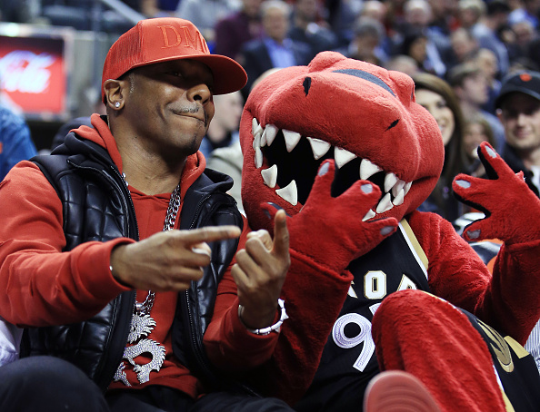 TORONTO, ON - MARCH 30: Rapper Sisqo hangs out with Toronto Raptors mascot The Raptor from his courtside seat during the first half of an NBA game between the Atlanta Hawks and the Toronto Raptors at the Air Canada Centre on March 30, 2016 in Toronto, Ontario, Canada. NOTE TO USER: User expressly acknowledges and agrees that, by downloading and or using this photograph, User is consenting to the terms and conditions of the Getty Images License Agreement. (Photo by Vaughn Ridley/Getty Images)