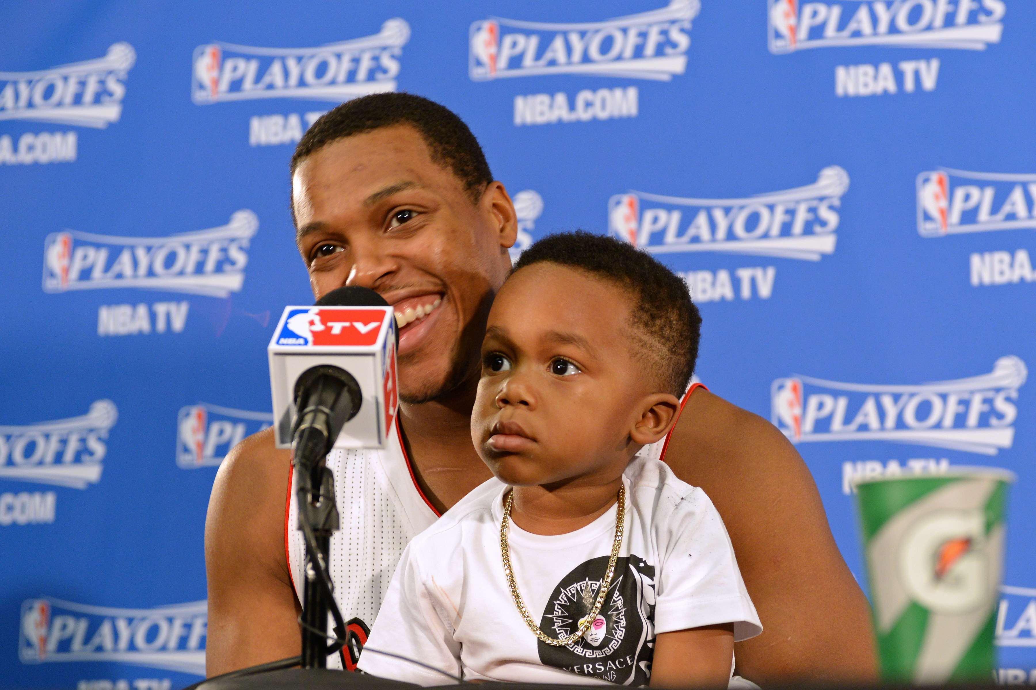 TORONTO, ON - MAY 4: Kyle Lowry #7 of the Toronto Raptors speaks to the media with his son after Game Seven of the Eastern Conference Quarterfinals against the Brooklyn Nets during the NBA Playoffs at the Air Canada Centre on May 4, 2014 in Toronto, Ontario, Canada. NOTE TO USER: User expressly acknowledges and agrees that, by downloading and/or using this photograph, user is consenting to the terms and conditions of the Getty Images License Agreement. Mandatory Copyright Notice: Copyright 2014 NBAE (Photo by Ron Turenne/NBAE via Getty Images)