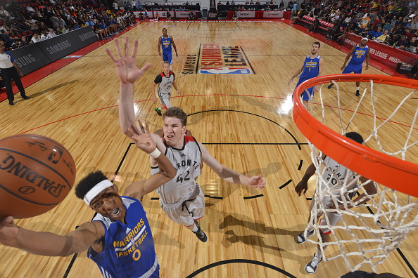 LAS VEGAS, NV - JULY 14: Patrick McCaw #0 of the Golden State Warriors goes to the basket against Jakob Poeltl #42 of the Toronto Raptors during the 2016 NBA Las Vegas Summer League game on July 14, 2016 at the Cox Pavillion in Las Vegas, Nevada. NOTE TO USER: User expressly acknowledges and agrees that, by downloading and or using this photograph, User is consenting to the terms and conditions of the Getty Images License Agreement. Mandatory Copyright Notice: Copyright 2016 NBAE (Photo by David Dow/NBAE via Getty Images)