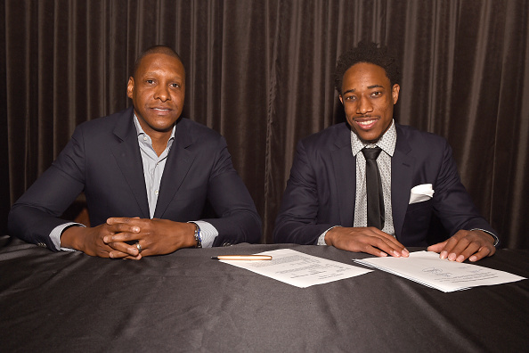 TORONTO, CANADA - JULY 14: DeMar DeRozan #10 and Masai Ujiri of the Toronto Raptors pose for a photo during a press conference after signing his new deal on July 14, 2016 at the Real Sports Bar & Grill in Toronto, Ontario, Canada. NOTE TO USER: User expressly acknowledges and agrees that, by downloading and or using this Photograph, user is consenting to the terms and conditions of the Getty Images License Agreement. Mandatory Copyright Notice: Copyright 2016 NBAE (Photo by Ron Turenne/NBAE via Getty Images