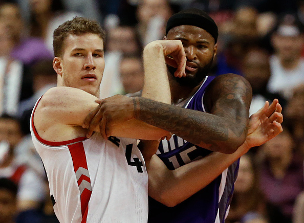 TORONTO, ON - NOVEMBER 6: Toronto Raptors center Jakob Poeltl (42) ties up Sacramento Kings center DeMarcus Cousins (15). Toronto Raptors vs Sacremento Kings in 2nd half action of NBA regular season play at Air Canada Centre. Raptors lose 96-91.Toronto Star/Rick Madonik (Rick Madonik/Toronto Star via Getty Images)