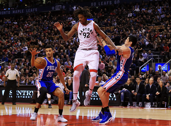 TORONTO, ON - NOVEMBER 28: Lucas Nogueira #92 of the Toronto Raptors battles for the ball with Timothe Luwawu-Cabarrot #20 and Ersan Ilyasova #7 of the Philadelphia 76ers defend during the second half of an NBA game against at Air Canada Centre on November 28, 2016 in Toronto, Canada. NOTE TO USER: User expressly acknowledges and agrees that, by downloading and or using this photograph, User is consenting to the terms and conditions of the Getty Images License Agreement. (Photo by Vaughn Ridley/Getty Images)