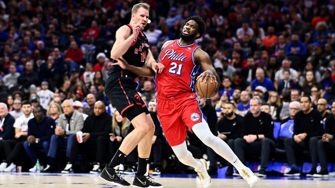 Philadelphia 76ers center Joel Embiid (21) moves against Toronto Raptors center Jakob Poeltl (19) in the second quarter at Wells Fargo Center.