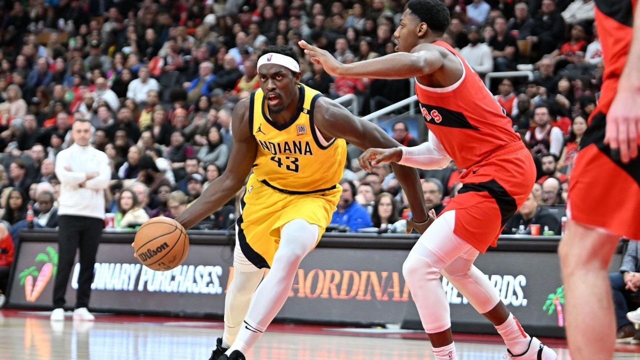 Indiana Pacers forward Pascal Siakam (43) dribbles the ball past Toronto Raptors forward RJ Barrett (9) in the first half at Scotiabank Arena.
