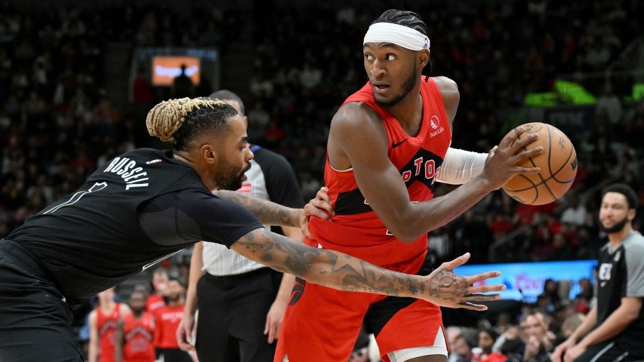 Toronto Raptors guard Immanuel Quickley (5) keeps the ball away from Brooklyn Nets guard D'Angelo Russell (1) in the second half at Scotiabank Arena.
