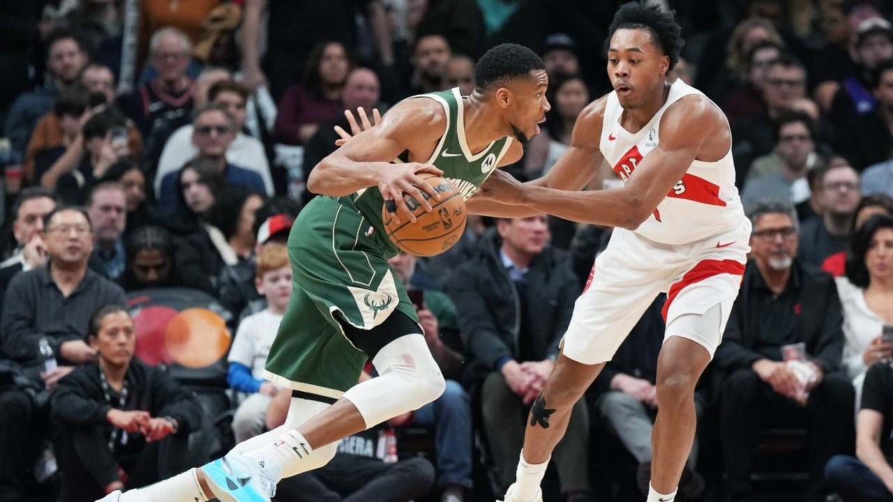 Milwaukee Bucks forward Giannis Antetokounmpo (34) controls the ball as Toronto Raptors forward Scottie Barnes (4) defends during the third quarter at Scotiabank Arena